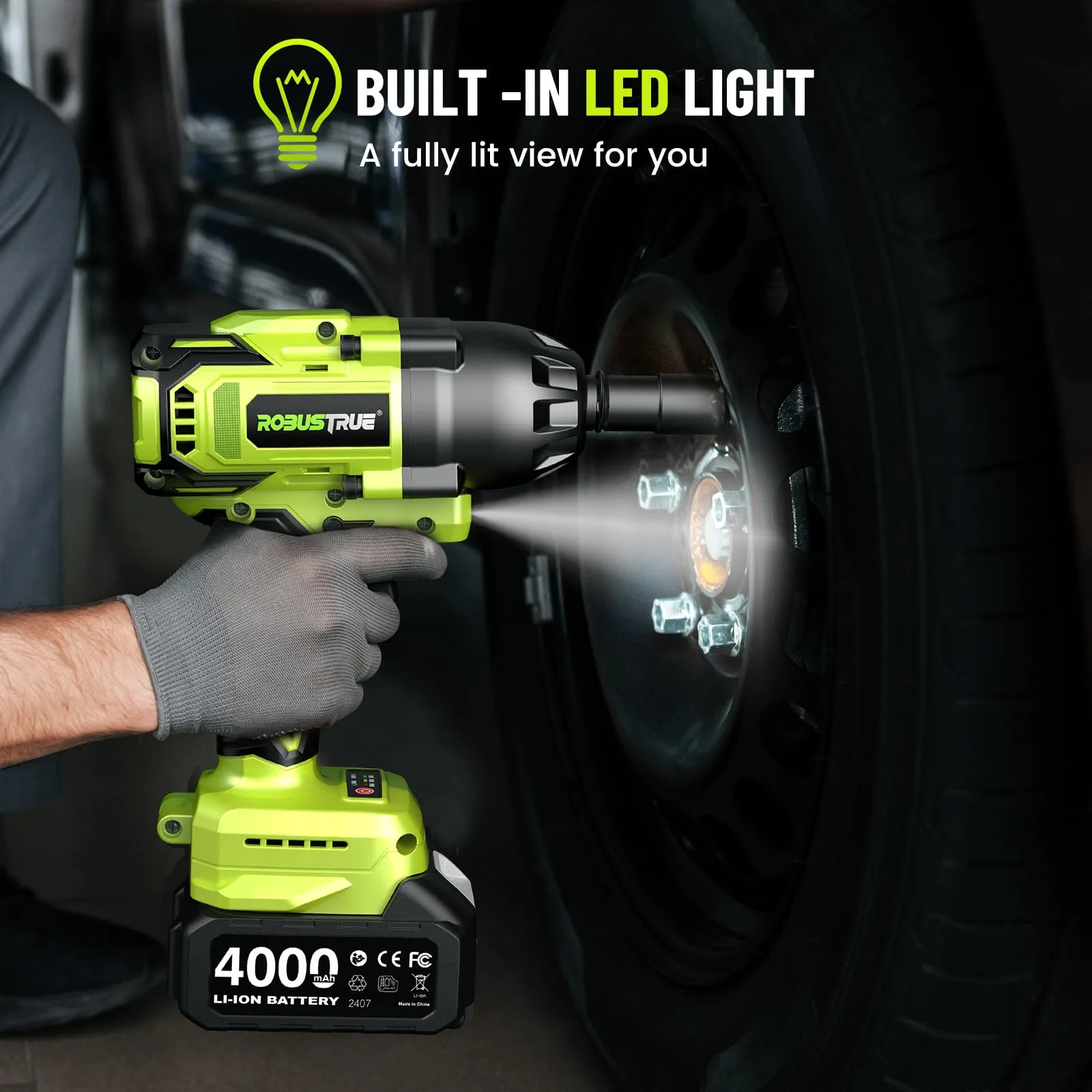Robustrue impact wrench with its LED light on, working on a car wheel in a dark garage
